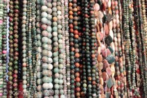 Drapes of earth-toned bead necklaces